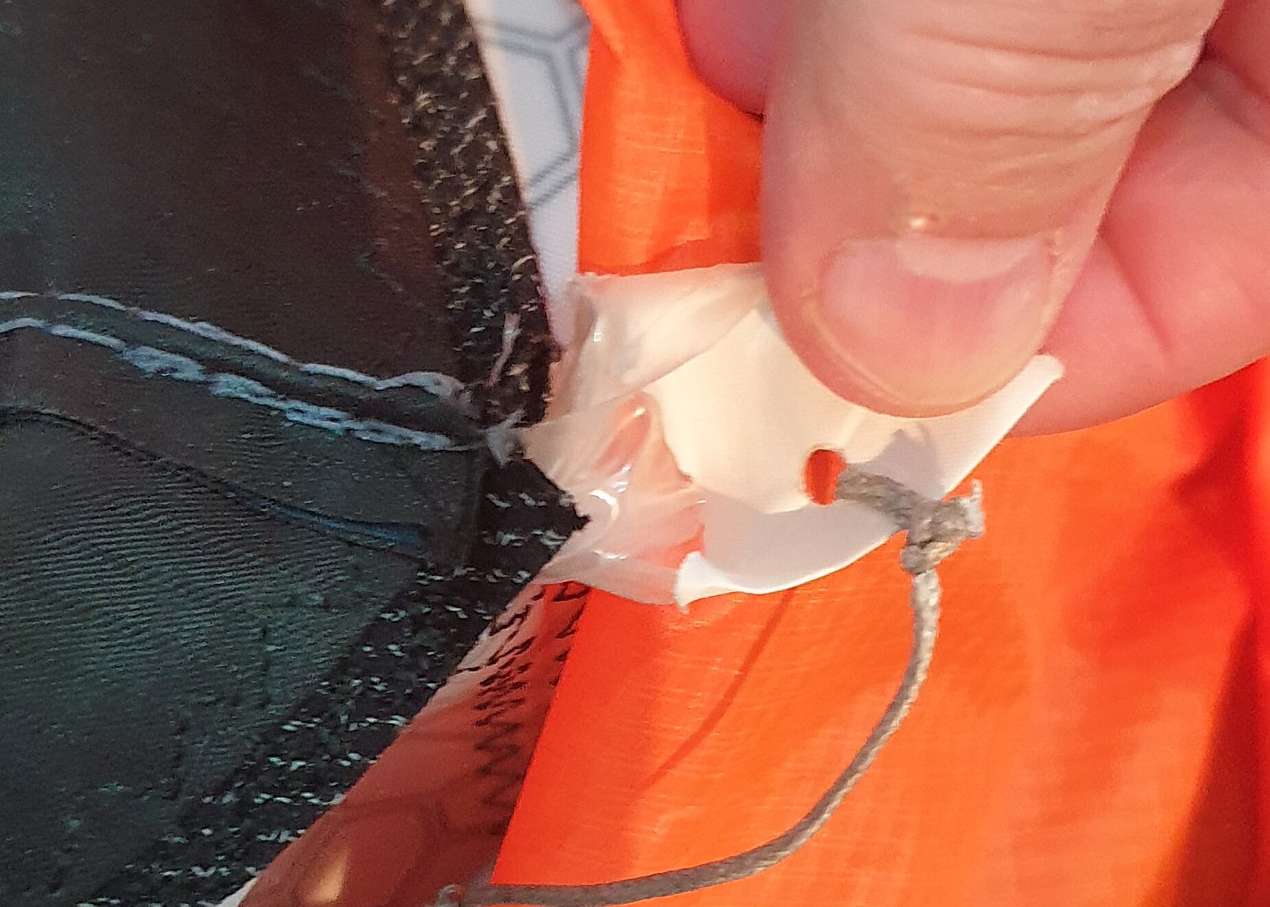 Strut bladder nose outside the strut fabric, missing or over-tightened locking line, exposed TPU at fabric edge, off-centre nose